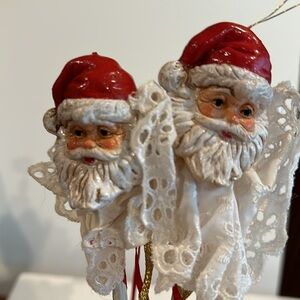 Set of two Santa Claus ornaments on a stick
